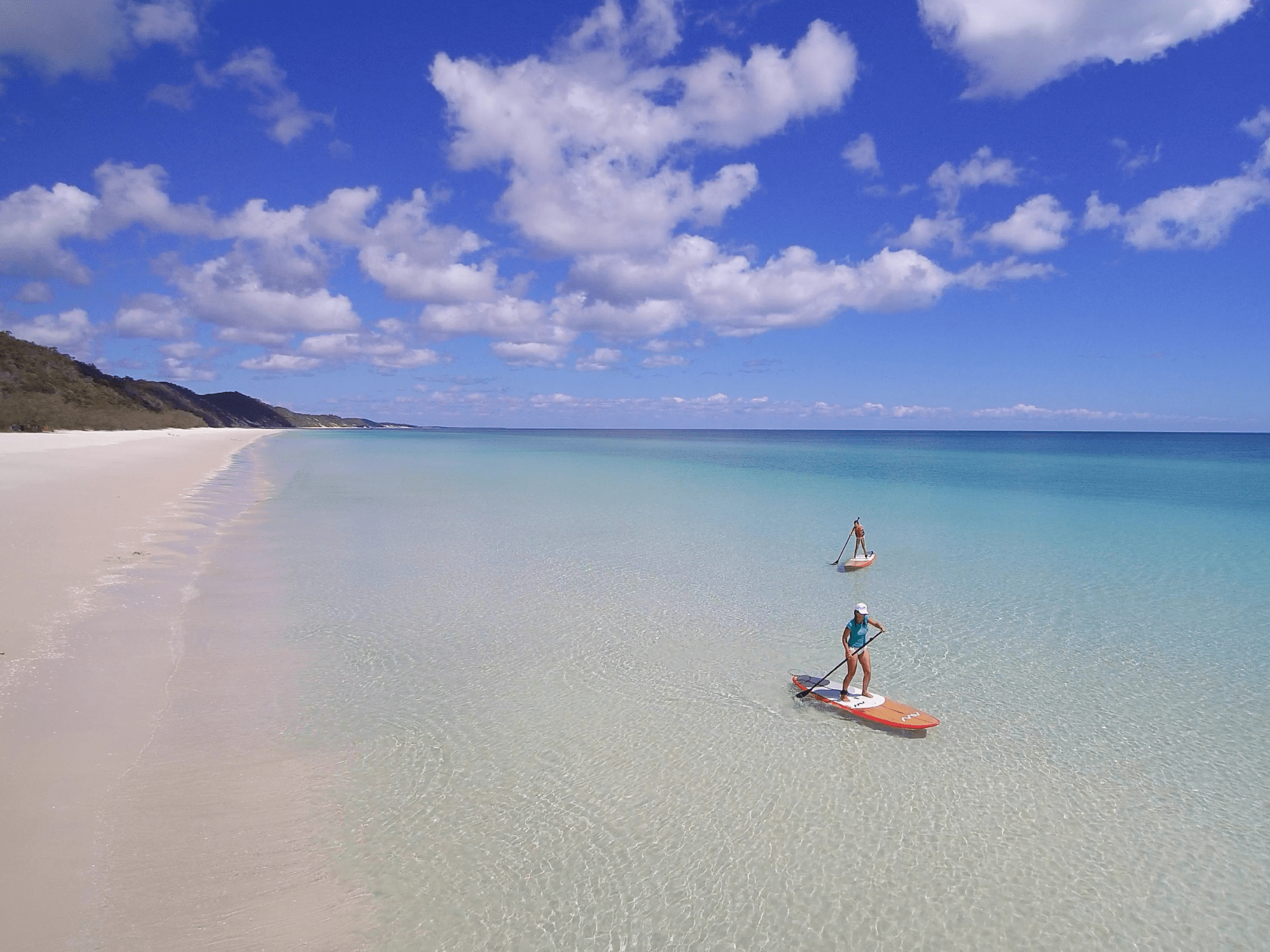 Stand up paddle boarding on K'gari with Tasman Venture Island Escapes Private Charters